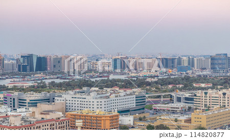 Deira modern and old buildings canal aerial view of Dubai Creek day to night timelapse. Deira modern and old buildings canal aerial view of Dubai Creek day to night timelapse. 114820877