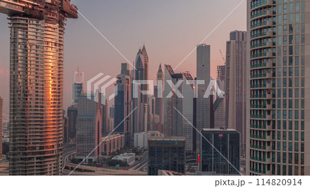 Dubai International Financial Centre district with modern skyscrapers timelapse at sunrise Dubai International Financial Centre district with modern skyscrapers timelapse at sunrise 114820914