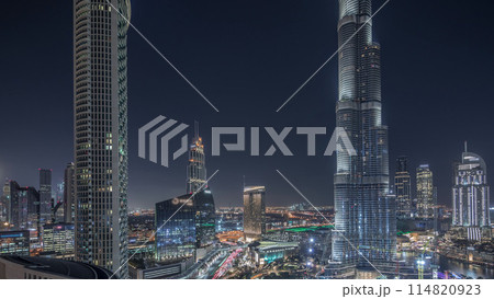Panoramic skyline view of Dubai downtown with mall, fountains and skyscrapers aerial night timelapse Panoramic skyline view of Dubai downtown with mall, fountains and skyscrapers aerial night timelapse 114820923