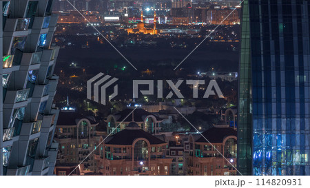 Aerial view to neighborhood Deira and Dubai creek with typical old and modern buildings night timelapse. 114820931