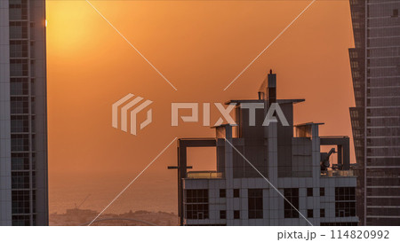 Sunset behind modern residential and office complex aerial timelapse at Business Bay, Dubai 114820992