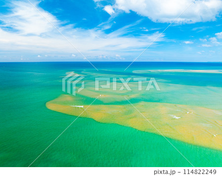 Aerial view of a blue sea surface water texture background,Sun reflections over ocean, Aerial flying drone view Waves water surface texture on sunny tropical ocean in Phuket island Thailand Aerial view of a blue sea surface water texture background,Sun reflections over ocean, Aerial flying drone view Waves water surface texture on sunny tropical ocean in Phuket island Thailand 114822249