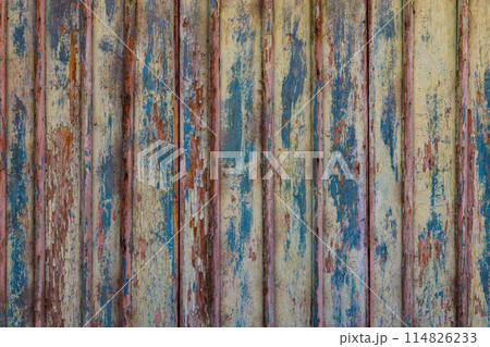 old wooden planks board texture with peeled brown and blue paint layers under sun-bleached blue paint layer 114826233
