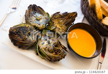 Grilled artichokes with romesco sauce 114828167