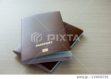 Passport for International travel and business laid out on a wooden background. Copy space background 114830738