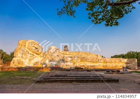 Large white reclining Buddha statue at Wat Lokayasutharam. Ayutthaya Historical Park, Thailand 114834957