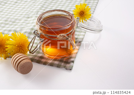 Dandelion honey and fresh flowers. Close up Dandelion honey and fresh flowers. Close up 114835424