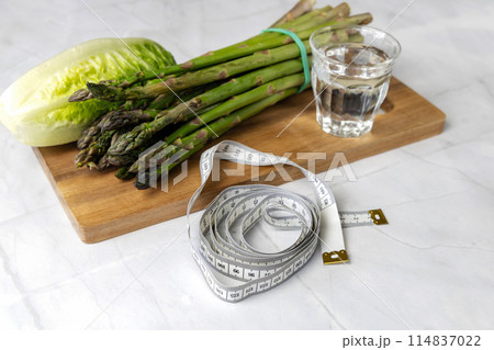 Fresh vegetables on the kitchen table cabbage, salad, asparagus. 114837022