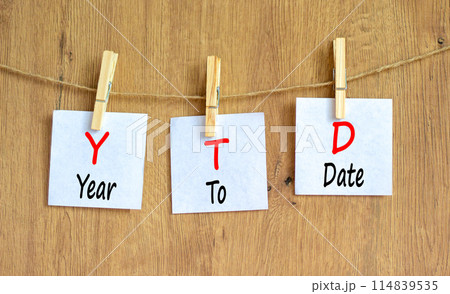 YTD year to date symbol. Concept words YTD year to date on beautiful white paper. Beautiful wooden background. Business YTD year to date concept. Copy space. YTD year to date symbol. Concept words YTD year to date on beautiful white paper. Beautiful wooden background. Business YTD year to date concept. Copy space. 114839535