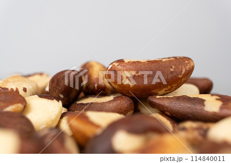 Macro brazil nuts on light grey background. 114840011