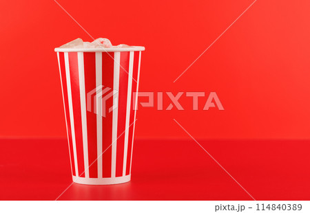 Paper cup with cola and ice over red background 114840389