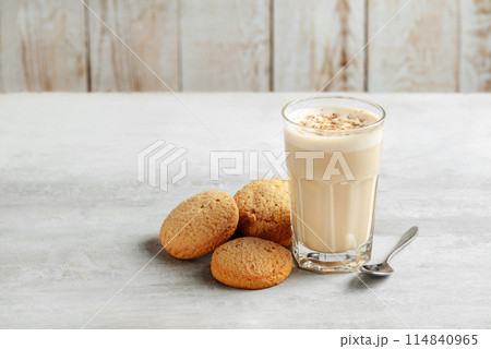coffee raff in a glass close-up with homemade cookies. coffee with milk and grated nut on light background. 114840965