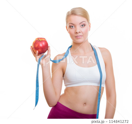 Diet. Fit girl with measure tape and apple fruit 114841272
