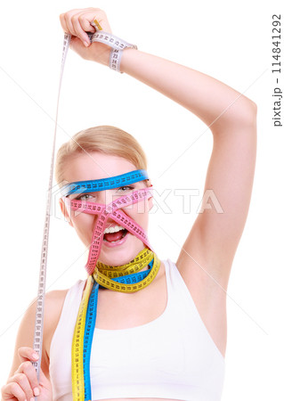 Obsessed fitness woman with a lot of colorful measure tapes Obsessed fitness woman with a lot of colorful measure tapes 114841292