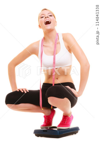 Happy woman on weighing scale. Healthy lifestyle. Happy woman on weighing scale. Healthy lifestyle. 114841338