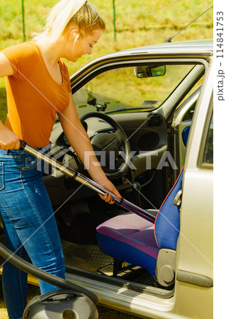 Cleaning car interior with vacuum cleaner Cleaning car interior with vacuum cleaner 114841753