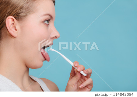 Girl with tongue cleaner. 114842084