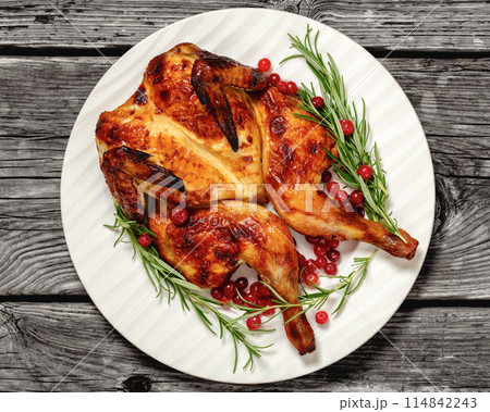 butterflied, spatchcock roast chicken on a plate 114842243