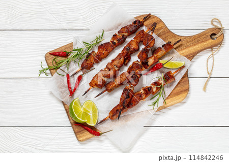 fried juicy pork kebabs on wooden cutting board fried juicy pork kebabs on wooden cutting board 114842246