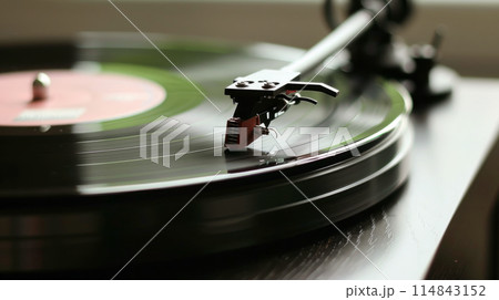 Vinyl Record Spinning on Turntable - Classic Music and Retro Audio Concept 114843152