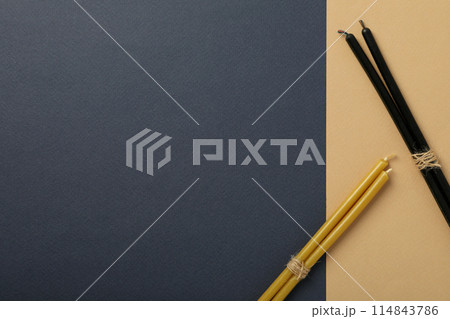 Light and dark magic candles twisted into a pile. 114843786