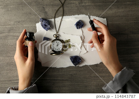 A set of magical things on a dark table. 114843787