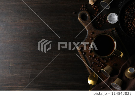 Coffee capsules, coffee beans and cup on wooden background, space for text 114843825
