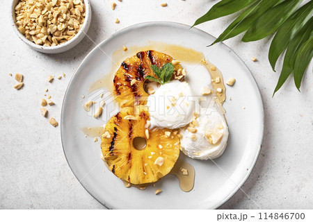 Grilled pineapples with icecream, tropical dessert Grilled pineapples with icecream, tropical dessert 114846700