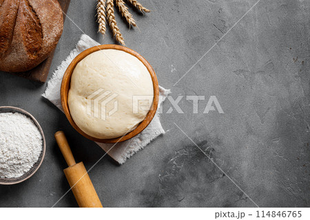 Baking and kneading background with ball of dough Baking and kneading background with ball of dough 114846765