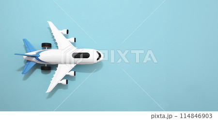White airplane layout on a blue background. Summer vacation and plane travel, booking tickets 114846903