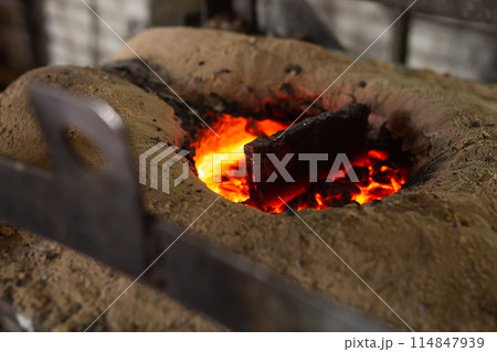 Ferrous metal billet is melted in an induction furnace closeup 114847939