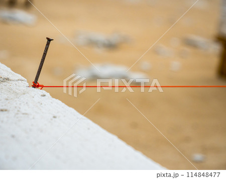 String used as level in the construction of wall. String used as level in the construction of wall. 114848477