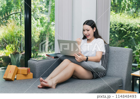 Successful entrepreneur business woman with online sales and Parcel shipping in her home office. Woman checking order on digital tablet. Successful entrepreneur business woman with online sales and Parcel shipping in her home office. Woman checking order on digital tablet. 114848493