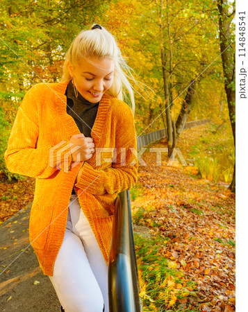 Attractive woman walking in autumn park Attractive woman walking in autumn park 114848541
