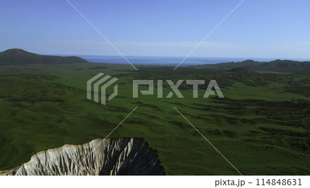 Aerial view of summer green valley and stony cleft. Clip. Flying above stunning summer hilly region. 114848631