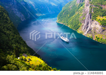 A big cruise liner in clear azure water of Sunnylvsfjorden fjord A big cruise liner in clear azure water of Sunnylvsfjorden fjord 114848891