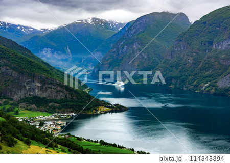 A big cruise liner in Sunnylvsfjorden fjord near Geiranger village A big cruise liner in Sunnylvsfjorden fjord near Geiranger village 114848894