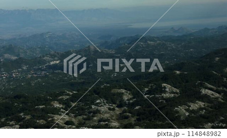 Big green mountains. Creative. A bird's-eye view of the high mountains with green trees and gray sky mist above. Big green mountains. Creative. A bird's-eye view of the high mountains with green trees and gray sky mist above. 114848982