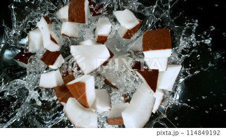 Fresh coconut pieces falling into water, top down view Fresh coconut pieces falling into water, top down view 114849192