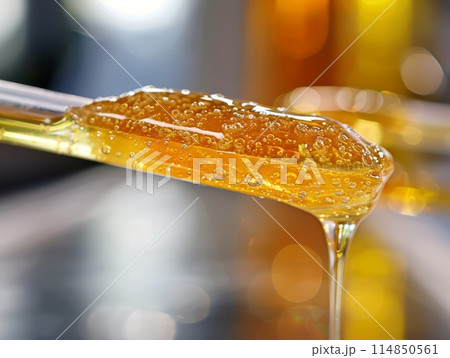 Yellow bowl filled with sweet honey, ready for dipping 114850561