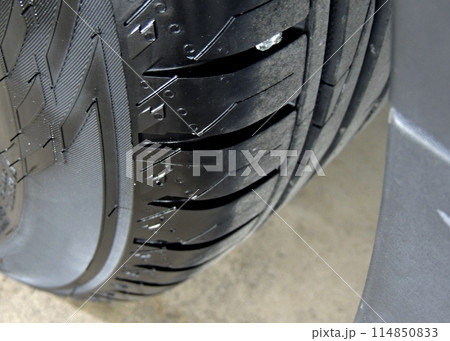 Overhead view of cleaned car tire on the concrete floor close up Overhead view of cleaned car tire on the concrete floor close up 114850833