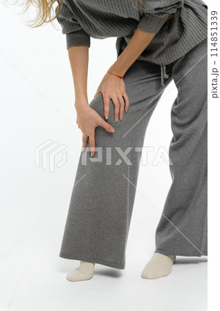 Woman holding hands on knees. 114851339