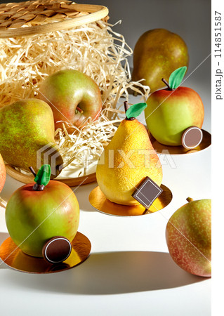 Desserts in shape of pear and apple with fresh fruits and straw basket 114851587