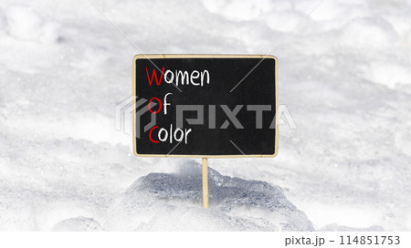 WOC women of color symbol. Concept words WOC women of color on beautiful yellow blackboard. Beautiful white snow background. Business WOC women of color social issues concept. Copy space. 114851753