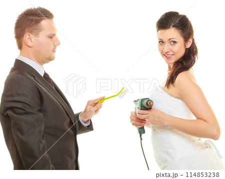 Bride and groom sharing household duties Bride and groom sharing household duties 114853238