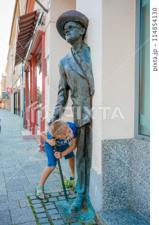 Child run and play on street on Szombathely in Hungary. Traveling in Szombathely city, Hungary. Child run and play on street on Szombathely in Hungary. Traveling in Szombathely city, Hungary. 114854130