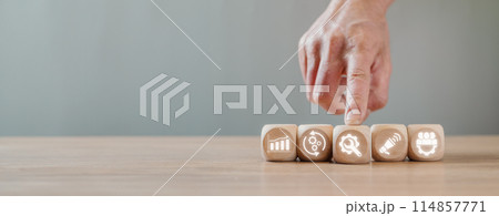 Value chain concept, Hand holding wooden block on desk with value chain icon on virtual screen. 114857771