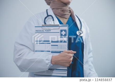 Doctor holding clipboard and stethoscope on background of Hospital ward 114858837