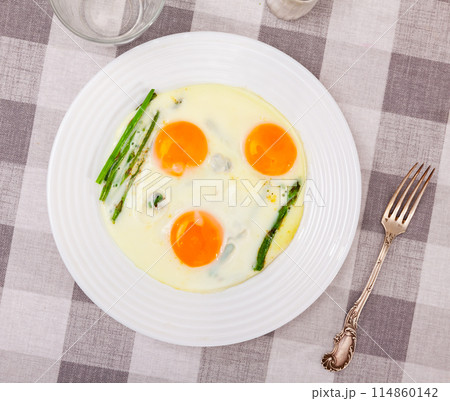 Homemade healthy breakfast: fried eggs and asparagus closeup Homemade healthy breakfast: fried eggs and asparagus closeup 114860142
