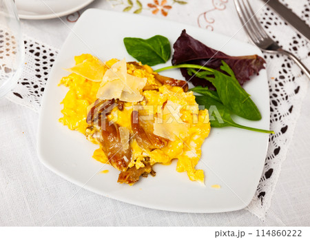 Scrambled eggs with mushrooms and cheese served with greens Scrambled eggs with mushrooms and cheese served with greens 114860222